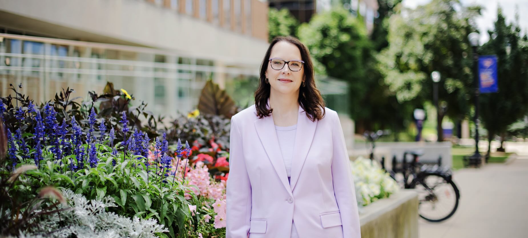 President MacLatchy in lavender suit in a garden