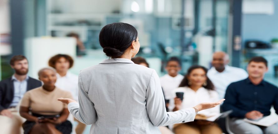 Woman facilitating training to others seated