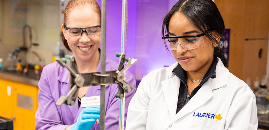 Lab coordinator working with student