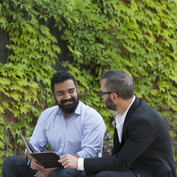 two people talking on a bench