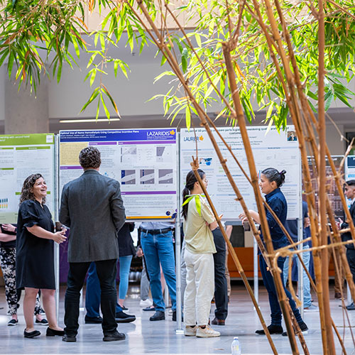students browse graduate research fair