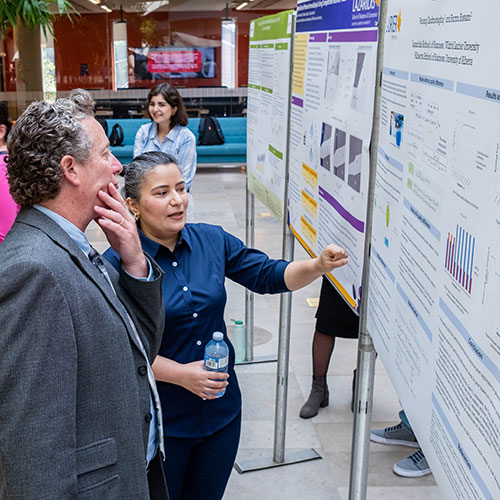 student shares research with professor
