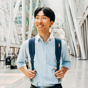 Smiling student wearing a backpack