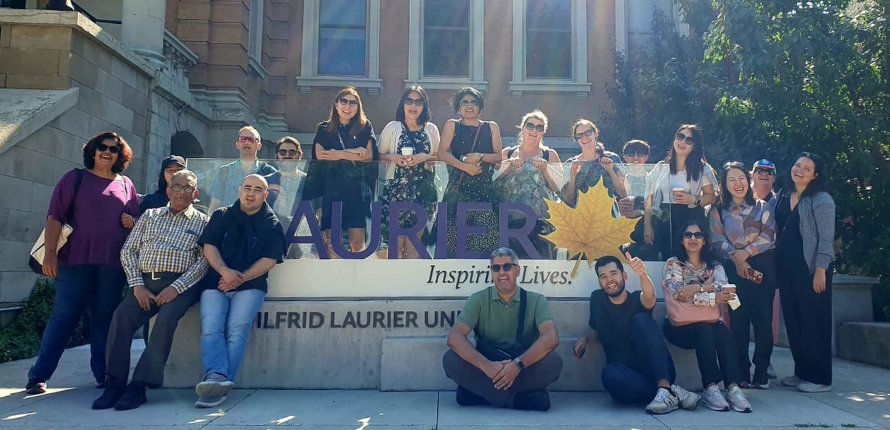 group of people in front of the laurier sign