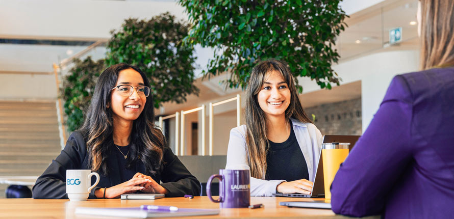 two female laurier co-op students in business setting