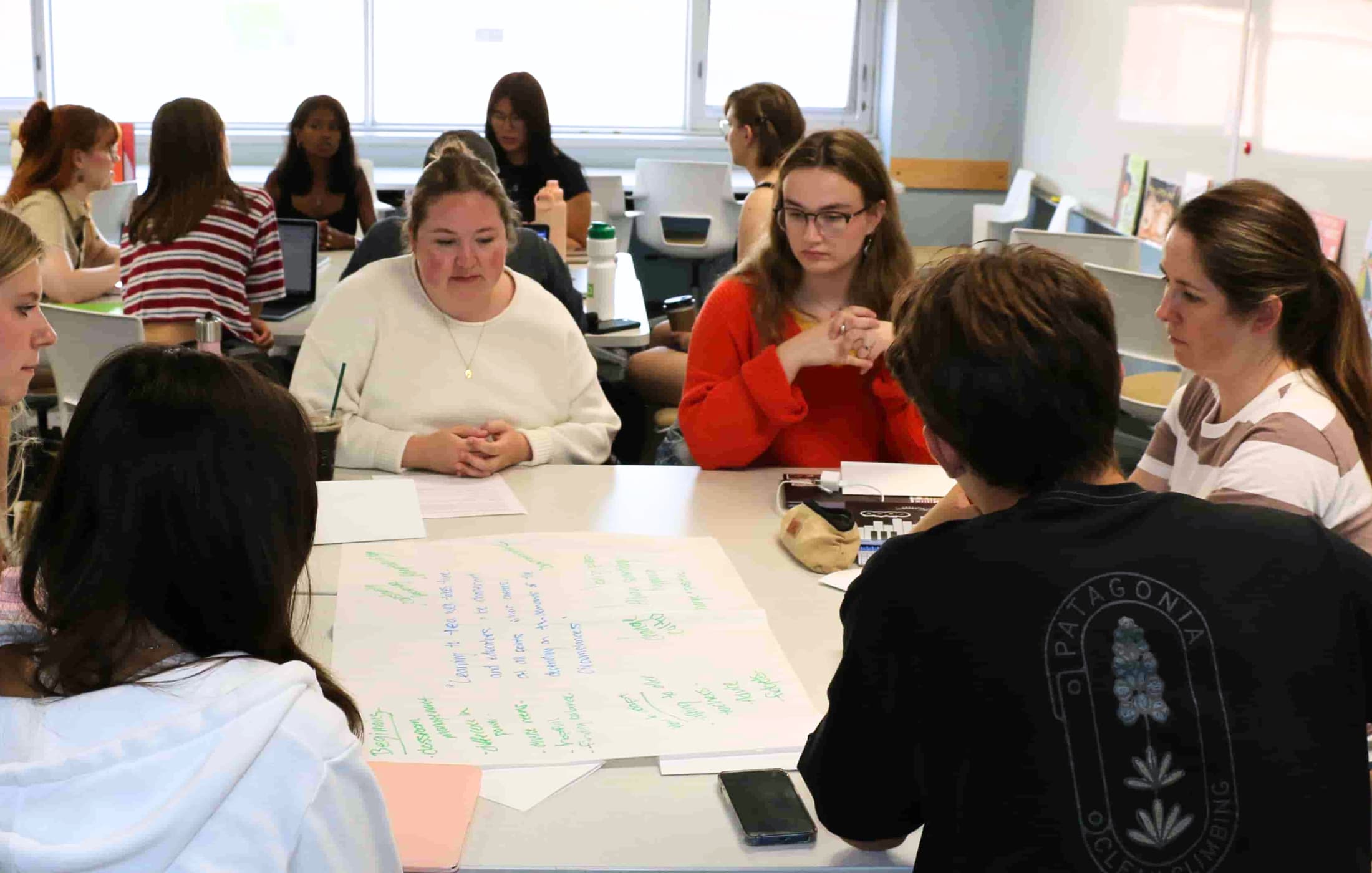 Women sitting around a table in a classroom.